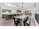 Dining room with modern lighting, a table with a bench, and an open-concept view of the kitchen at 807 E Harvard Ave, Gilbert, AZ 85234