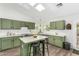 Bright kitchen featuring an island, stainless steel appliances, and ample cabinet space with skylights at 807 E Harvard Ave, Gilbert, AZ 85234