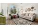 Bright living room featuring comfortable seating, a large arched window, and stylish decor at 807 E Harvard Ave, Gilbert, AZ 85234