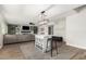 Open-concept living area featuring a kitchen island, living room with a large sectional, and wood-style flooring at 807 E Harvard Ave, Gilbert, AZ 85234