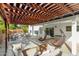 Inviting covered patio with stylish seating, hanging chairs, and decorative lighting, perfect for outdoor living and entertaining at 807 E Harvard Ave, Gilbert, AZ 85234