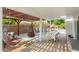 Shaded outdoor living area with pergola, hanging chairs, and dining space at 807 E Harvard Ave, Gilbert, AZ 85234