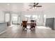 Bright dining area features tile, neutral carpet, multiple windows, and a ceiling fan at 8317 W Cocopah St, Tolleson, AZ 85353