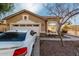 Charming home featuring a two-car garage, landscaped front yard, and inviting curb appeal at 8317 W Cocopah St, Tolleson, AZ 85353