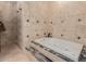 A tiled bathroom featuring a jacuzzi bathtub, a separate tiled shower, and tiled walls at 8749 E Via De Sereno --, Scottsdale, AZ 85258