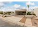 Well-maintained property featuring covered parking and neatly arranged desert landscaping at 8749 E Via De Sereno --, Scottsdale, AZ 85258