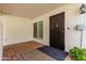 Welcoming front door featuring a security screen door, brick floor and small garden at 8749 E Via De Sereno --, Scottsdale, AZ 85258