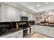 Modern kitchen featuring white cabinets, granite countertops, stainless steel appliances and modern recessed lighting at 8749 E Via De Sereno --, Scottsdale, AZ 85258