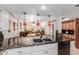 Open concept kitchen featuring a breakfast bar with pendant lights, sink, and stainless steel appliances at 8749 E Via De Sereno --, Scottsdale, AZ 85258
