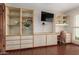 A bright office space featuring built-in shelving, wood tile floors, and a desk at 8749 E Via De Sereno --, Scottsdale, AZ 85258