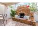 An outdoor brick fireplace featuring accent pillows and plants in a seating area at 8749 E Via De Sereno --, Scottsdale, AZ 85258
