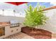 Close-up of the outdoor kitchen area, showcasing the built-in grill and greenery at 8749 E Via De Sereno --, Scottsdale, AZ 85258