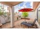 Charming outdoor kitchen area with a built-in grill, lounging area, and a vibrant red umbrella at 8749 E Via De Sereno --, Scottsdale, AZ 85258