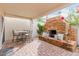 Charming covered patio featuring a stone fireplace and cozy seating area for outdoor relaxation at 8749 E Via De Sereno --, Scottsdale, AZ 85258