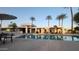 Inviting community pool surrounded by palm trees, tables, and lounge seating at 8749 E Via De Sereno --, Scottsdale, AZ 85258