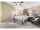 Spacious bedroom featuring neutral walls, carpet, and a king bed with a padded headboard and matching furniture at 9853 W Tonopah Dr, Peoria, AZ 85382