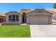 Attractive single-story home with a low-maintenance yard and covered entry at 9853 W Tonopah Dr, Peoria, AZ 85382