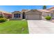 Inviting single-story home featuring a well-manicured lawn and a two-car garage at 9853 W Tonopah Dr, Peoria, AZ 85382