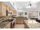 Well-equipped kitchen featuring granite countertops, stainless steel appliances, and ample cabinetry at 9853 W Tonopah Dr, Peoria, AZ 85382