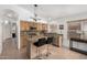 Bright kitchen featuring stainless steel appliances, tiled backsplash, and an island with barstools at 9853 W Tonopah Dr, Peoria, AZ 85382