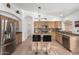 Functional kitchen design with stainless steel appliances, island with seating, and ample counter space at 9853 W Tonopah Dr, Peoria, AZ 85382