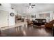 Open-concept living area with a kitchen bar, hardwood floors, and comfortable leather furniture at 9853 W Tonopah Dr, Peoria, AZ 85382