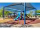 Community playground with a variety of play structures, slides and a covered picnic area nearby at 9853 W Tonopah Dr, Peoria, AZ 85382