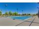 Well-maintained tennis courts with new nets and clear boundary lines, surrounded by trees at 9853 W Tonopah Dr, Peoria, AZ 85382
