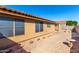 Exterior shot of a tan house featuring a patio and walkway surrounded by desert landscaping in backyard at 10510 W Louise Dr, Peoria, AZ 85383