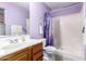 Well-lit bathroom featuring a shower, vanity, and lavender colored walls at 10510 W Louise Dr, Peoria, AZ 85383