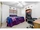 Well-lit carpeted bedroom with a ceiling fan and large window at 10510 W Louise Dr, Peoria, AZ 85383