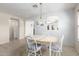 Bright dining room with chandelier, large window, and access to the kitchen at 10510 W Louise Dr, Peoria, AZ 85383