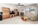 Bright living room with ceiling fan, built in shelving, and large windows at 10510 W Louise Dr, Peoria, AZ 85383