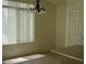 Dining area with a chandelier, a large window, and neutral-colored walls at 11206 W Granada Rd, Avondale, AZ 85392