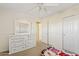 Bedroom featuring a dresser with mirror, ceiling fan and carpet flooring at 11405 E Rafael Ave, Mesa, AZ 85212