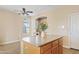 Bright dining area with a kitchen island, stylish ceiling fan, and neutral wall color at 11405 E Rafael Ave, Mesa, AZ 85212