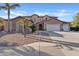 Inviting two-story home with desert landscaping, a rock garden, and three-car garage at 11405 E Rafael Ave, Mesa, AZ 85212