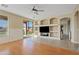 Inviting Living Room with built-in shelving, hardwood floors, and sliding glass door to backyard at 11405 E Rafael Ave, Mesa, AZ 85212