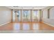 Well-lit Living Room with hardwood floors, light colored walls, and three large windows at 11405 E Rafael Ave, Mesa, AZ 85212