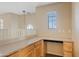 Office nook with built-in desk and cabinets, natural light, and neutral color palette at 11405 E Rafael Ave, Mesa, AZ 85212