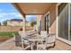 Covered patio with table and chairs overlooking a grassy backyard with mature landscaping at 11405 E Rafael Ave, Mesa, AZ 85212