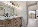 Bathroom featuring a double sink vanity and a large mirror with modern lighting at 11666 N 28Th Dr # 234, Phoenix, AZ 85029