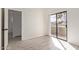 Light-filled bedroom featuring wood-look floors, white walls, and balcony access with exterior views at 11666 N 28Th Dr # 234, Phoenix, AZ 85029