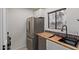 Modern kitchen featuring stainless steel refrigerator and updated sink at 11666 N 28Th Dr # 234, Phoenix, AZ 85029