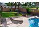 Beautiful backyard featuring a sparkling pool, poolside patio, and lush green lawn at 1213 N Raven --, Mesa, AZ 85207