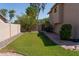 A spacious, well-maintained backyard featuring green grass and stone landscaping offers a serene outdoor retreat at 1213 N Raven --, Mesa, AZ 85207