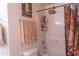 Well-lit bathroom featuring a shower with patterned curtain and tiled walls and neutral colored towels at 1213 N Raven --, Mesa, AZ 85207