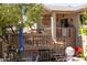 View of covered patio area with seating; backyard landscape, mature trees provide shade and privacy at 1213 N Raven --, Mesa, AZ 85207