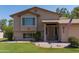 Charming two-story home with a well-maintained lawn, complemented by an American flag at 1213 N Raven --, Mesa, AZ 85207