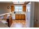 Bright kitchen featuring wood cabinets, a white dishwasher, and tile flooring, offering a functional cooking space at 1213 N Raven --, Mesa, AZ 85207